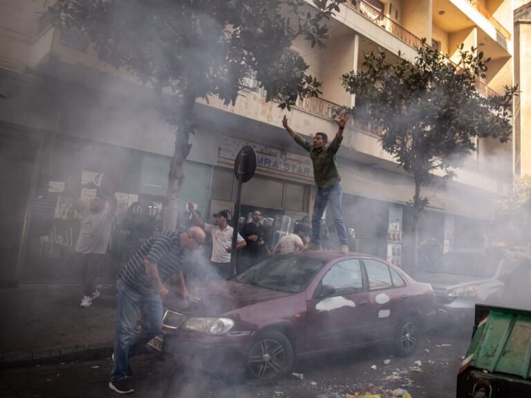 A Man Protests The Eviction Ontop Of A Car While Occupants Clash With Police 1730304390.jpg